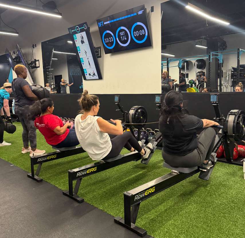 Athletes on rowing machines at BFT Tysons